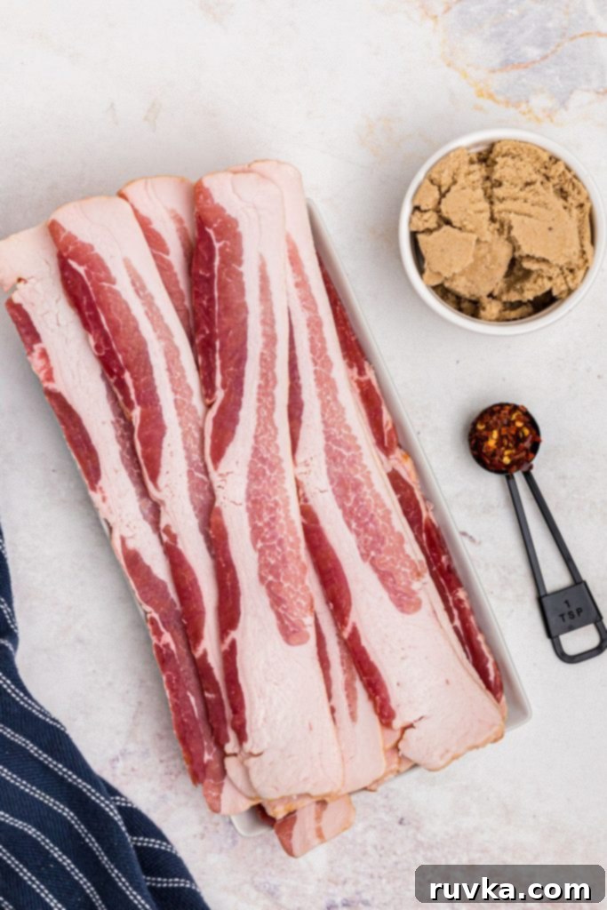Crispy Sweet Air Fryer Bacon 3 Bacon, brown sugar, and chili flakes on a marble table before being cooked