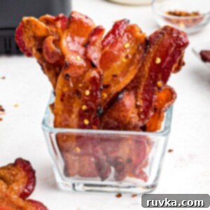 Crispy Sweet Air Fryer Bacon 10 Crispy juicy candied bacon in a clear glass jar.