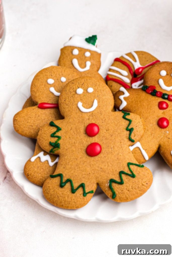 Quick and Easy Air Fryer Gingerbread Delights 12 A solitary golden gingerbread man cookie placed on a pristine white plate, awaiting decoration or enjoyment.