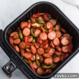 Crispy Air Fryer Sausage and Peppers 9 Sausage and peppers in an Air Fryer basket.