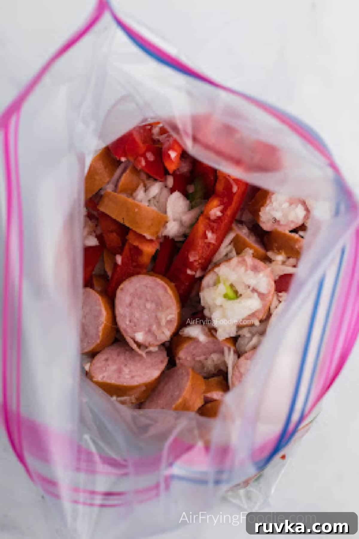 Crispy Air Fryer Sausage and Peppers 4 sausage, peppers, onion, oil, and seasonings added to a large sealable bag.