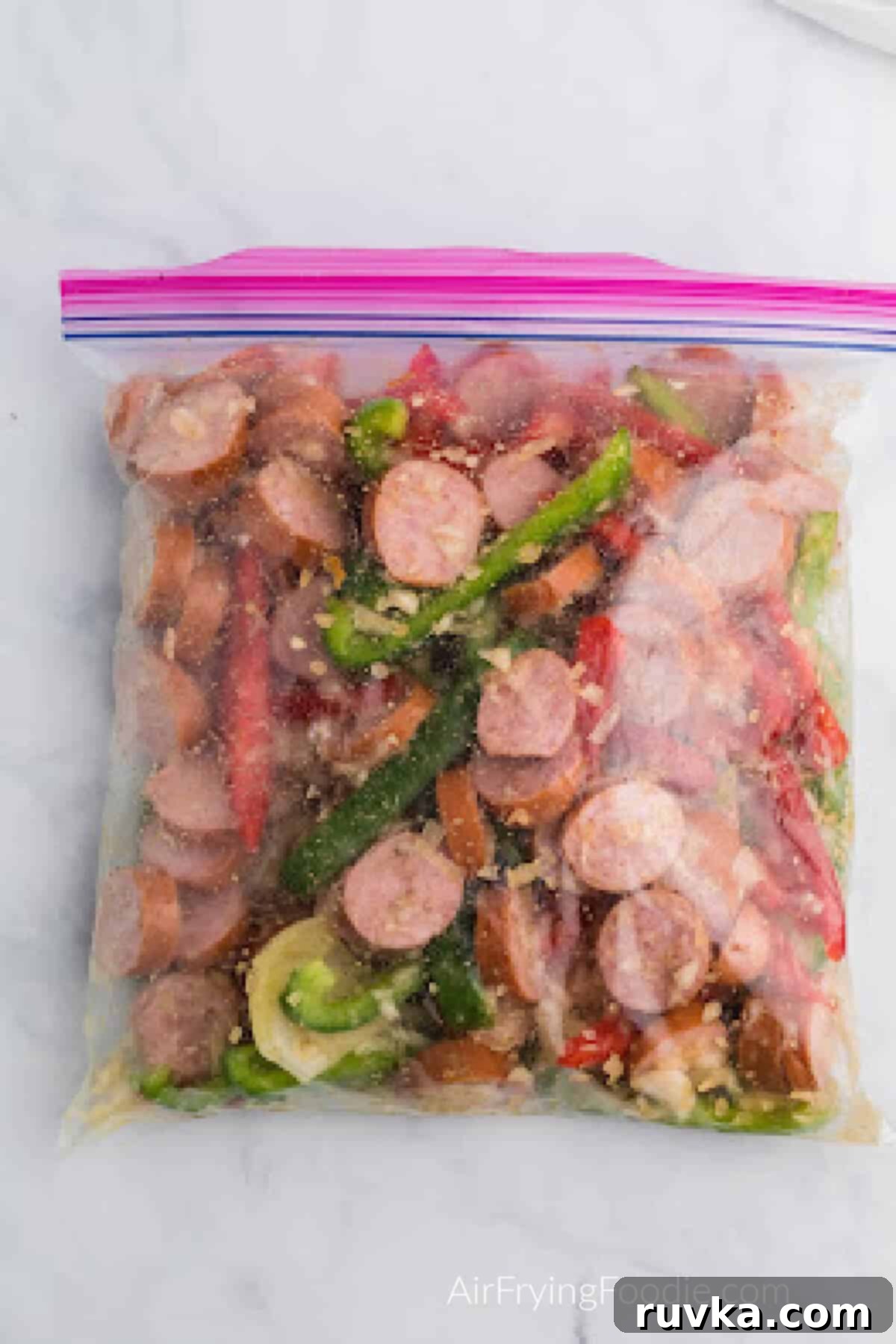 Crispy Air Fryer Sausage and Peppers 5 Ingredients tossed and coated in a sealable bag and ready to cook.