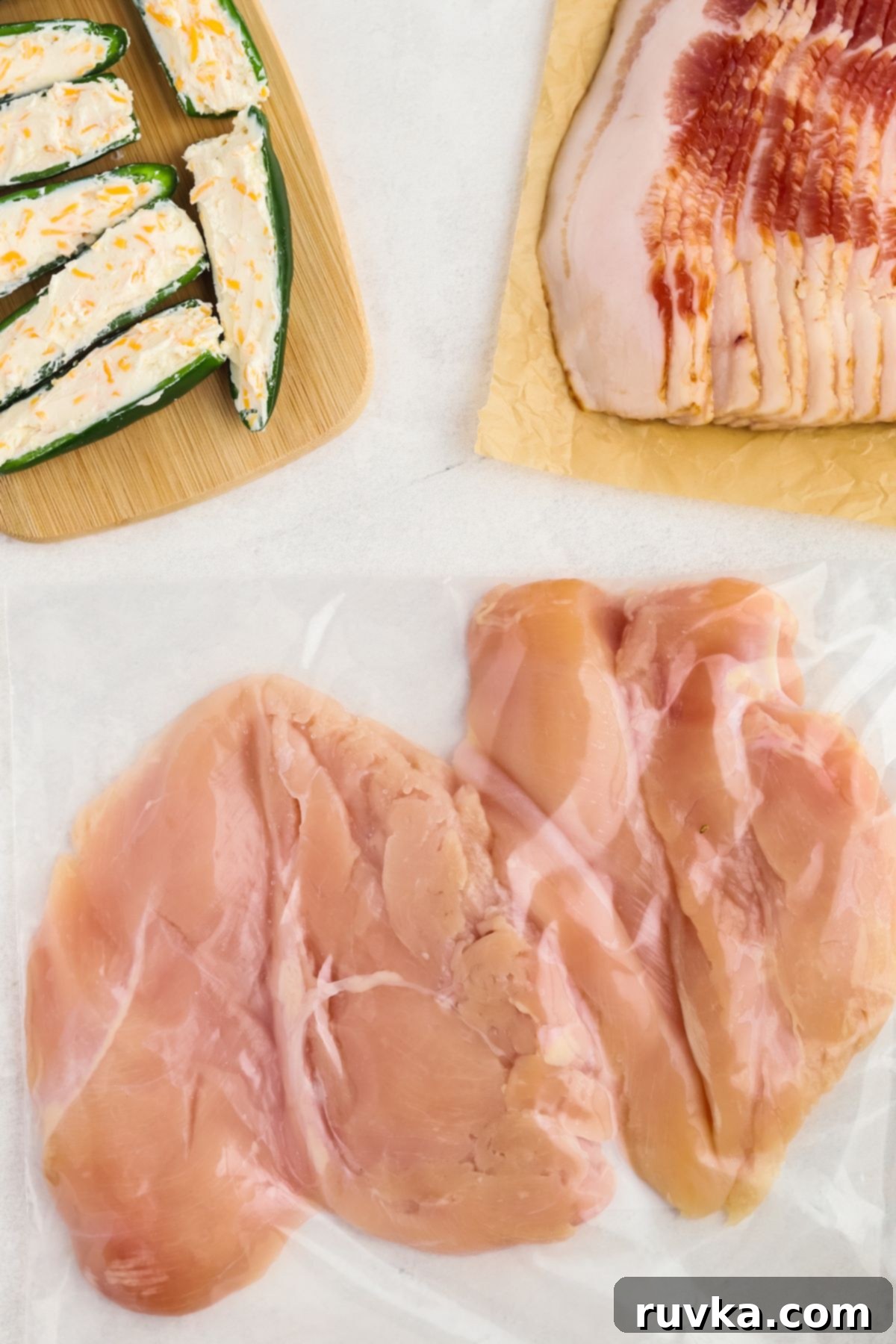 Crispy Air Fryer Chicken Jalapeno Poppers 6 Thinly pounded chicken breasts in a clear bag, ready for wrapping.
