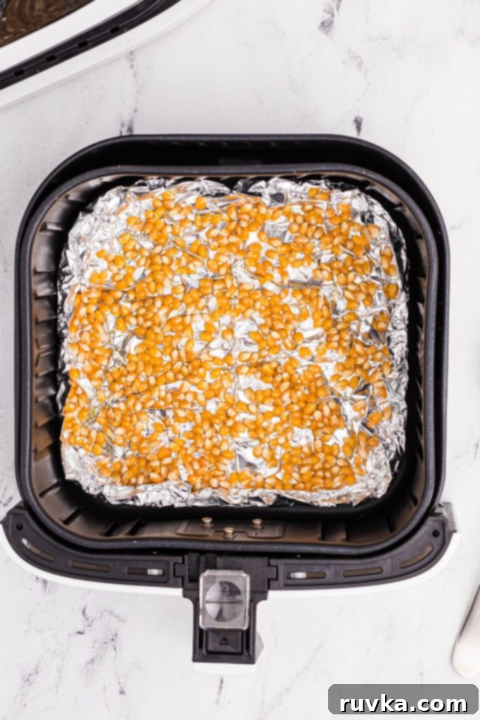 Air-Popped Perfection 5 Unpopped kernals in the air fryer basket on top of foil