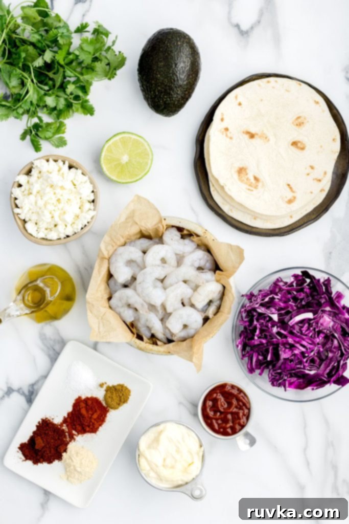 Crispy Air Fryer Shrimp Tacos 3 Assortment of fresh ingredients measured out around uncooked shrimp for delicious shrimp tacos