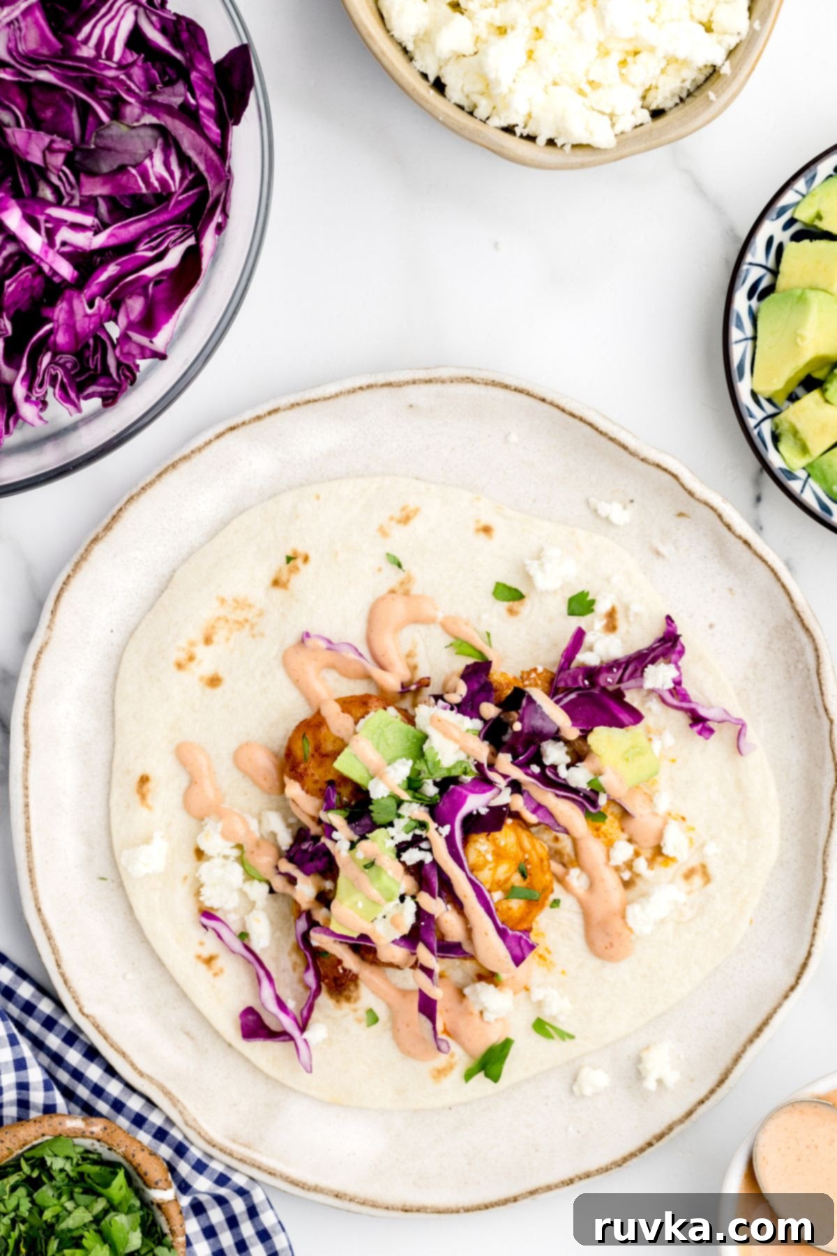 Crispy Air Fryer Shrimp Tacos 8 Shrimp on tortilla topped with colorful taco toppings and drizzled with spicy crema.