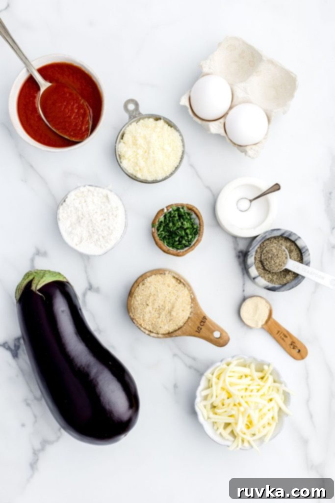 Air Fried Eggplant Parmesan 3 Ingredients needed to make eggplant parmesan measured out on a white marble table.