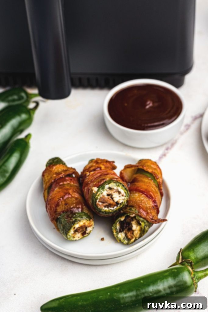 Perfect Air Fryer Texas Twinkies 2 Golden crispy bacon wrapped around jalapenos stuffed with cream cheese and bacon