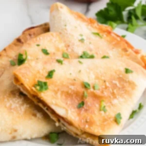 Crispy Air Fryer Pizza Quesadilla 11 Pizza quesadilla made in the air fryer and topped with parmesan cheese and parsley.