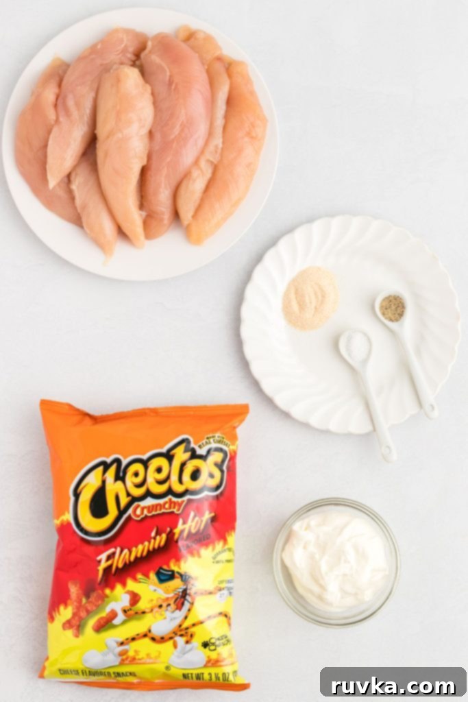 Crispy Air Fried Flamin Hot Cheetos Chicken 3 Ingredients needed to make flamin hot cheeto chicken on a white marble table