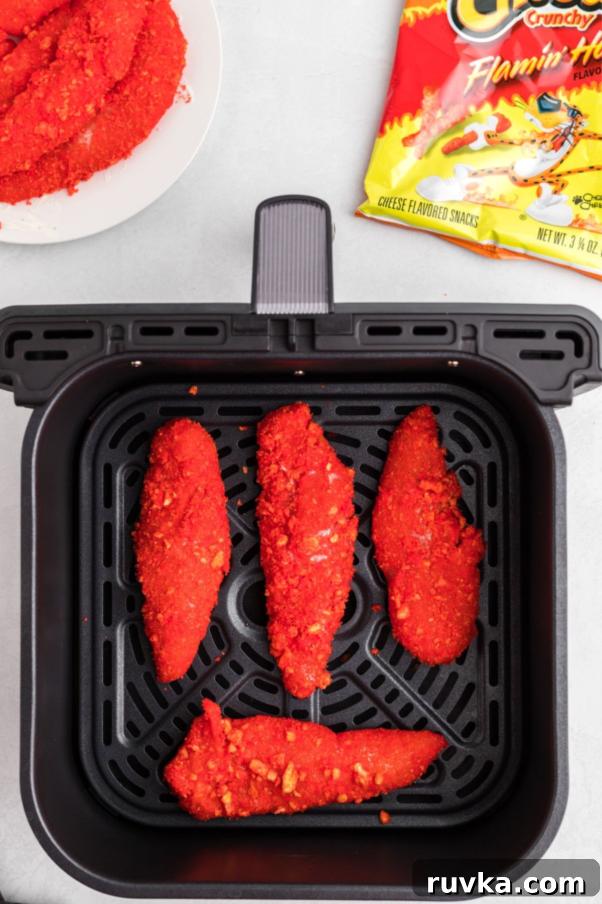 Crispy Air Fried Flamin Hot Cheetos Chicken 7 Coated cheeto chicken in the air fryer basket before being cooked