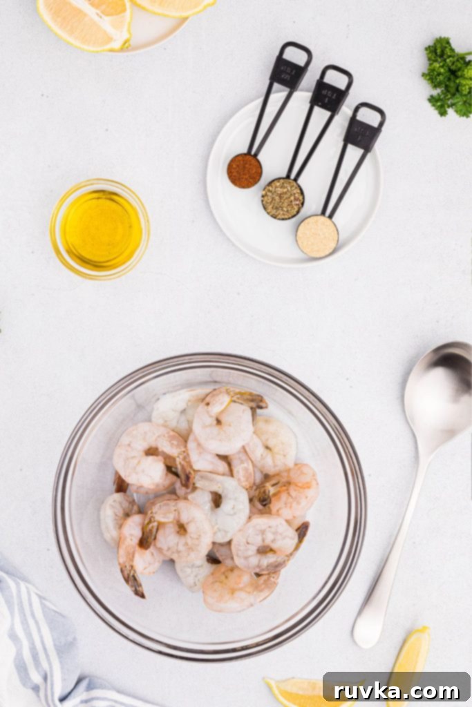 Crispy Air Fryer Shrimp 3 Ingredients needed to make seasoned shrimp measured out on a white marble table.