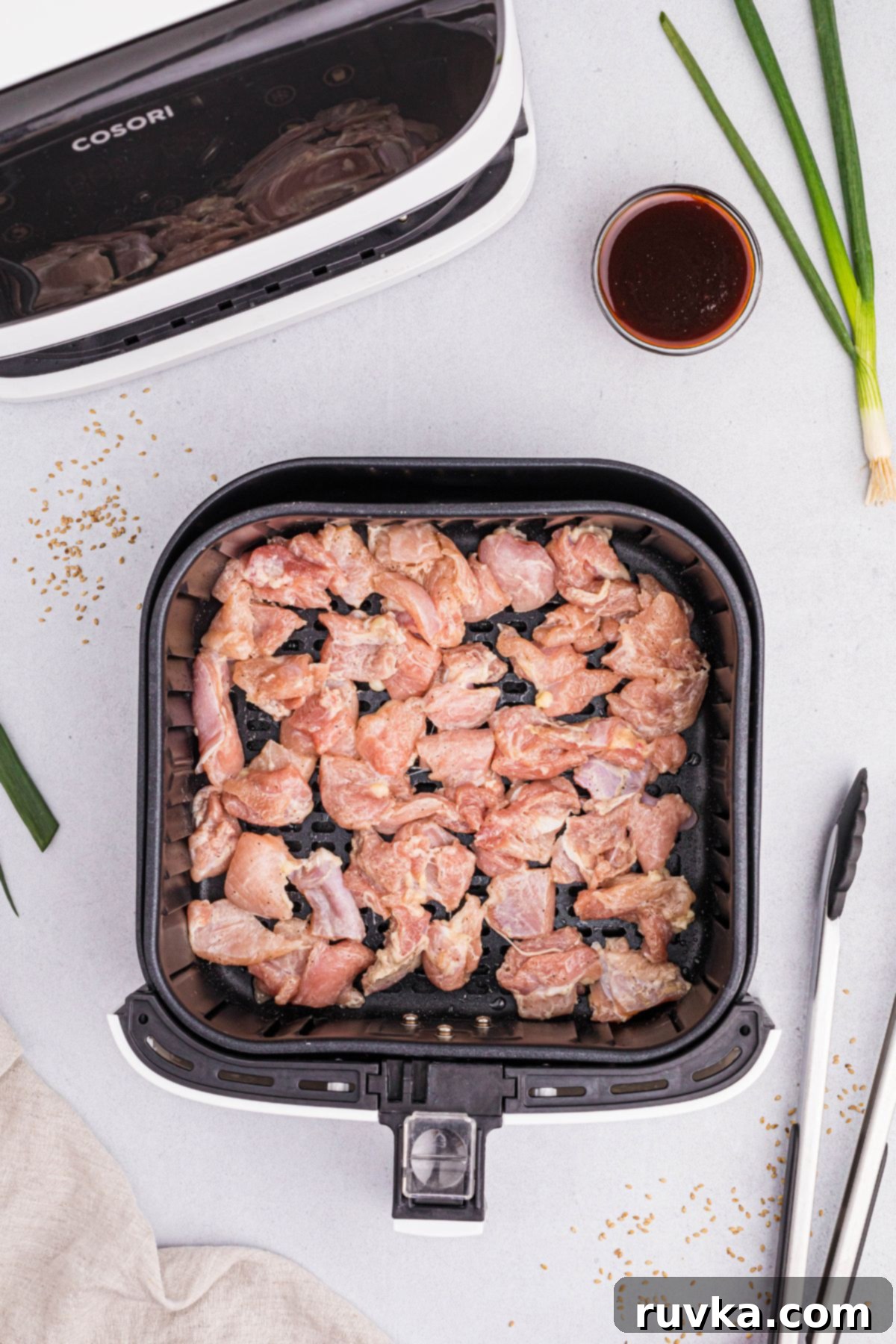 Crispy Air Fryer General Tso's Chicken 5 Uncooked chicken in the air fryer basket