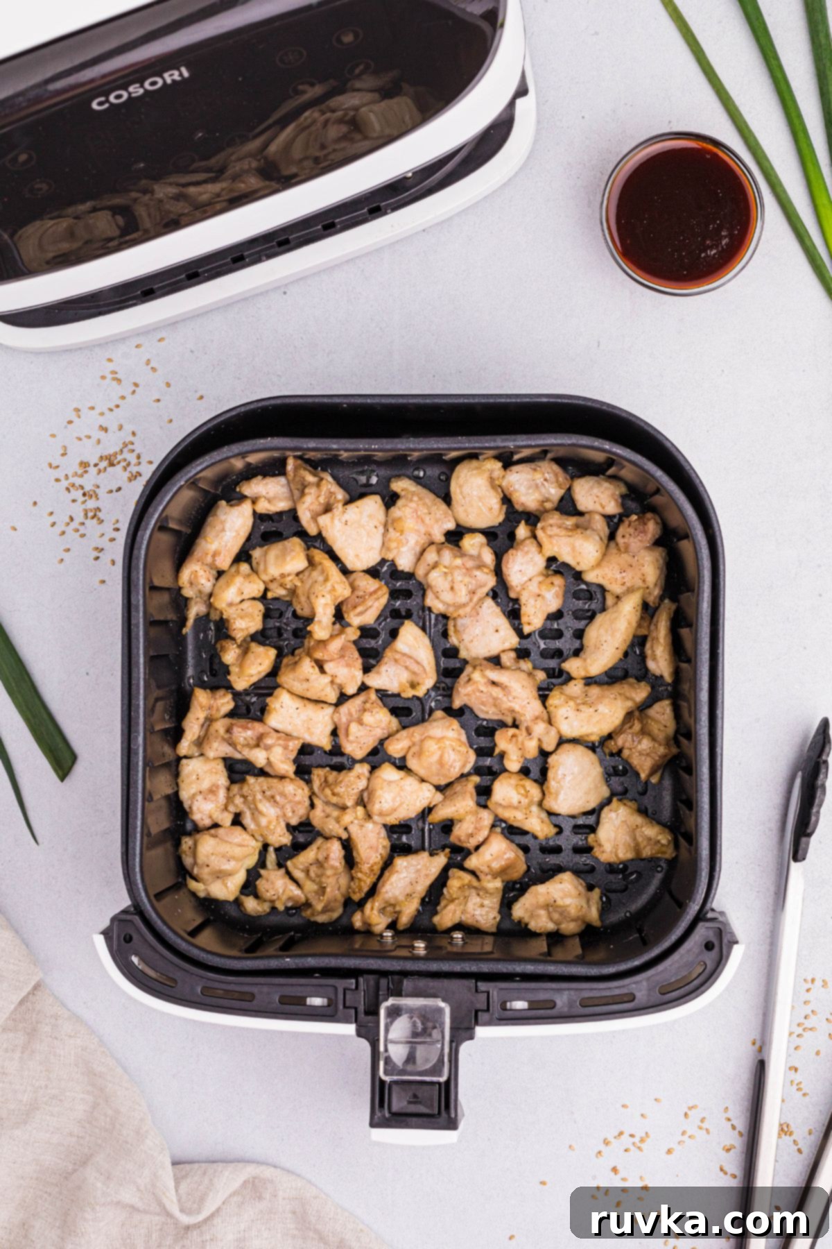 Crispy Air Fryer General Tso's Chicken 6 golden cooked pieces of chicken in the air fryer basket