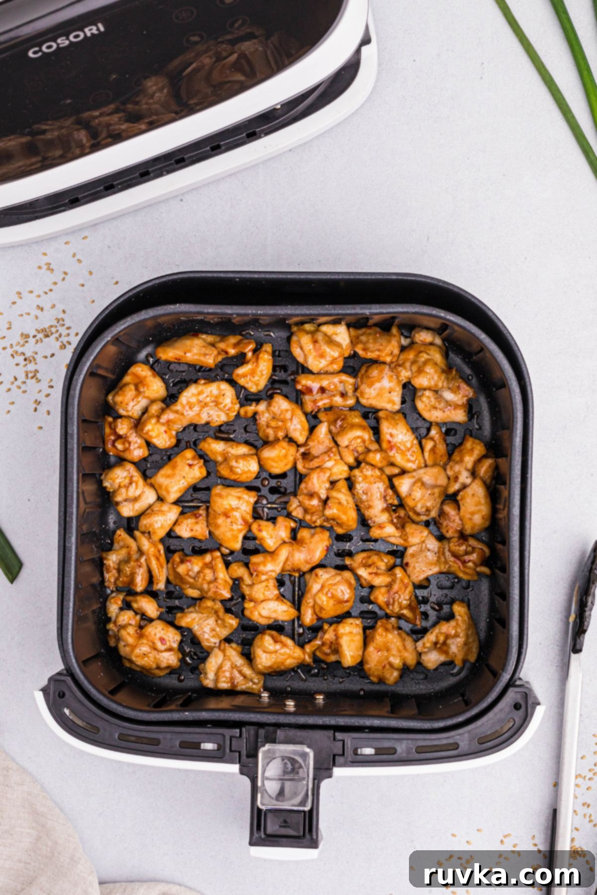 Crispy Air Fryer General Tso's Chicken 7 Golden cooked chicken tossed in General Tso's sauce and heated in the air fryer basket.