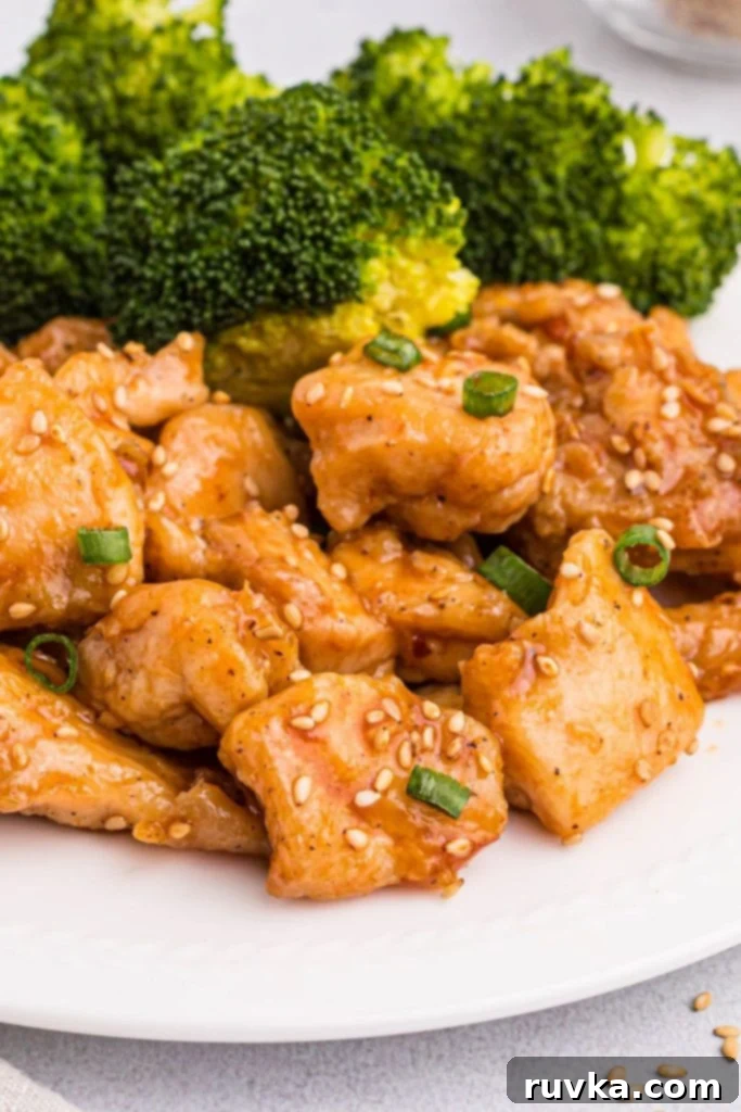 Crispy Air Fryer General Tso's Chicken 8 Golden juicy chicken pieces tossed in general tso's sauce and garnished with green onions and sesame seeds.