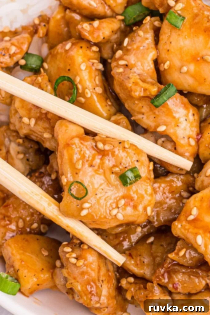 Crispy Air Fryer General Tso's Chicken 9 Golden juicy chicken pieces tossed in general tso's sauce and garnished with green onions and sesame seeds.