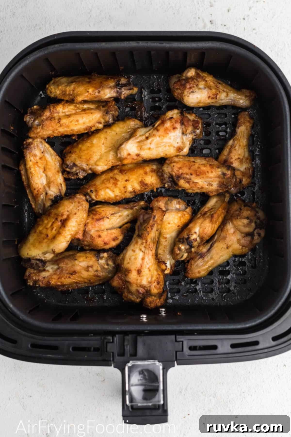 Crispy Air-Fried BBQ Wings 4 Crispy air fryer chicken wings cooking in the air fryer basket.