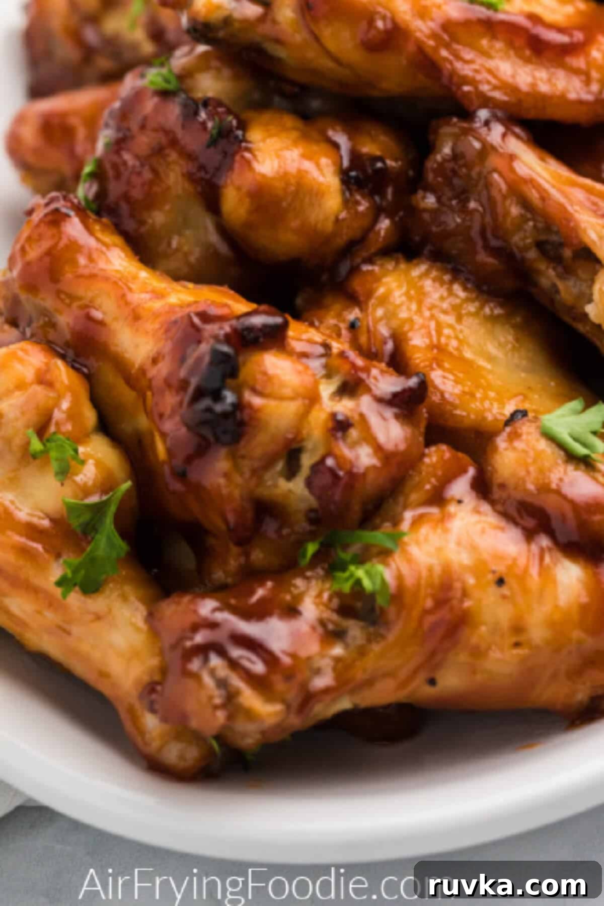 Crispy Air-Fried BBQ Wings 6 Close up of air fryer bbq chicken wings on a white serving platter.