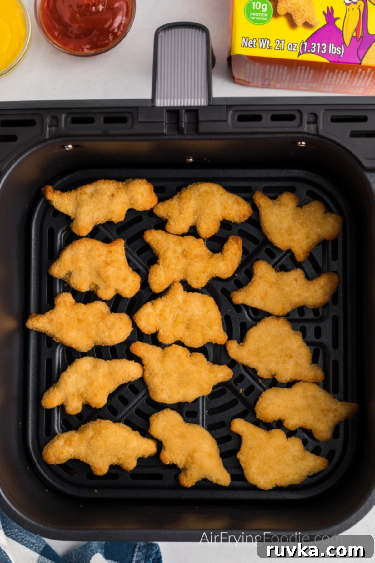 Crispy Air Fryer Dino Nuggets 5 Single layer of air fried dino nuggets in the air fryer basket.
