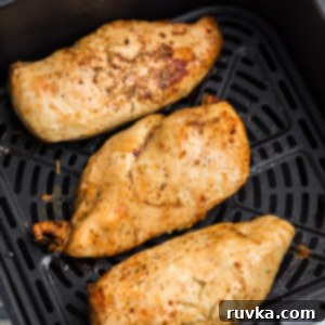 Juicy Air Fryer Grilled Chicken Breast 8 Overhead shot of grilled chicken breast in the basket of the air fryer.