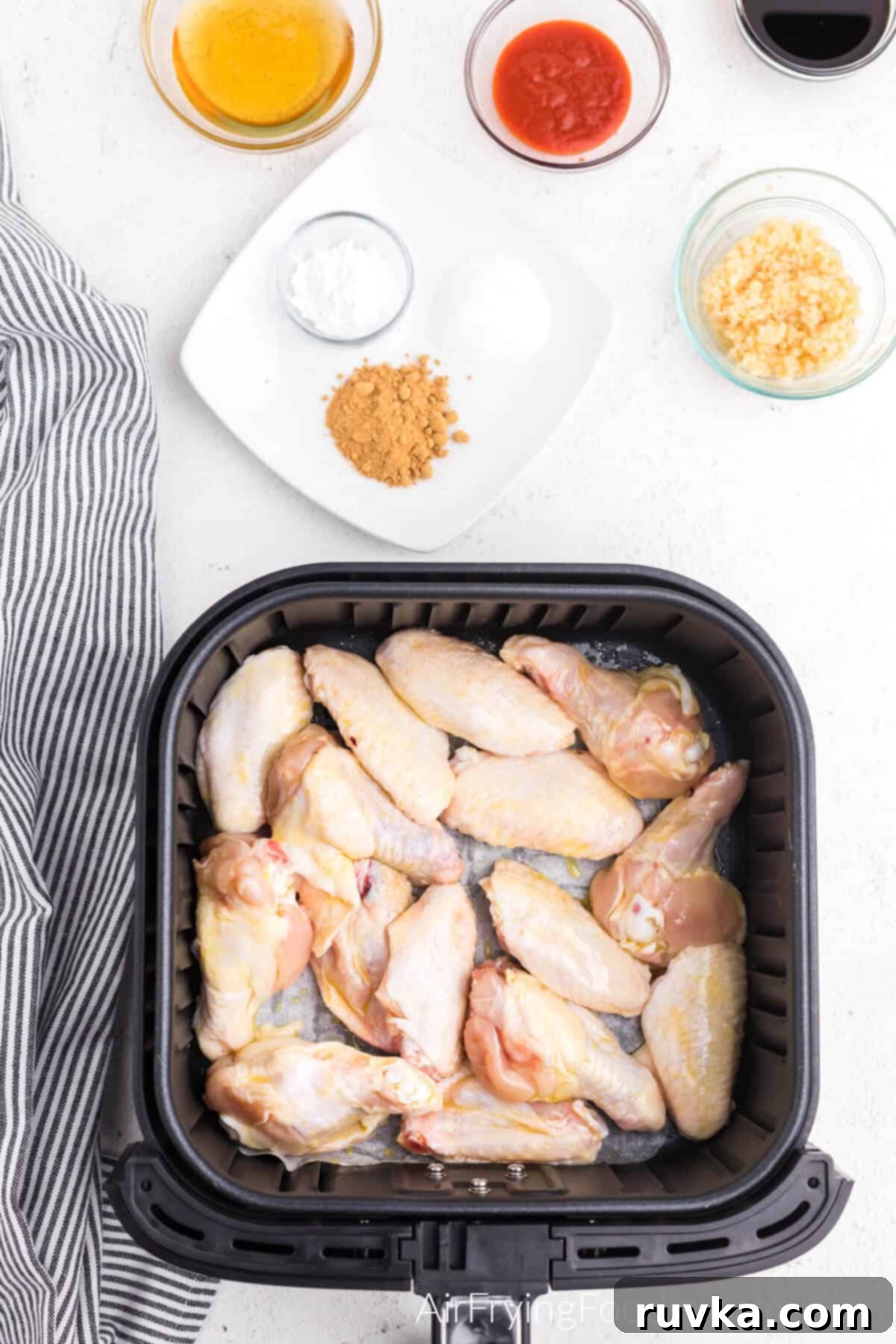Crispy Honey Garlic Air Fryer Wings 6 chicken wings in the basket of the air fryer.