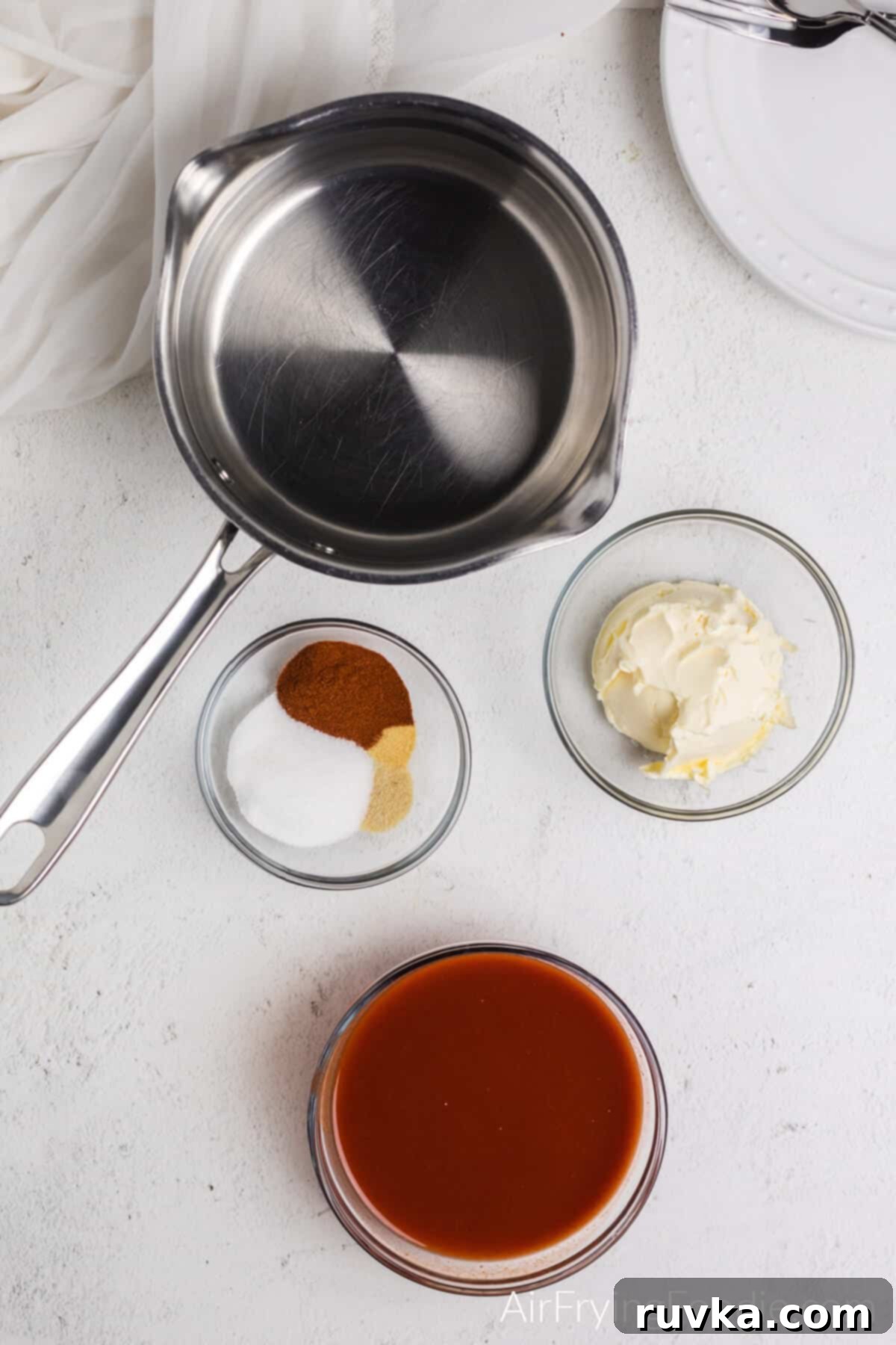 Crispy Air Fryer Buffalo Wings 5 Ingredients needed to make the homemade wing sauce: sauce pan, hot sauce in a bowl, seasonings in a bowl, and margarine or butter in a bowl.