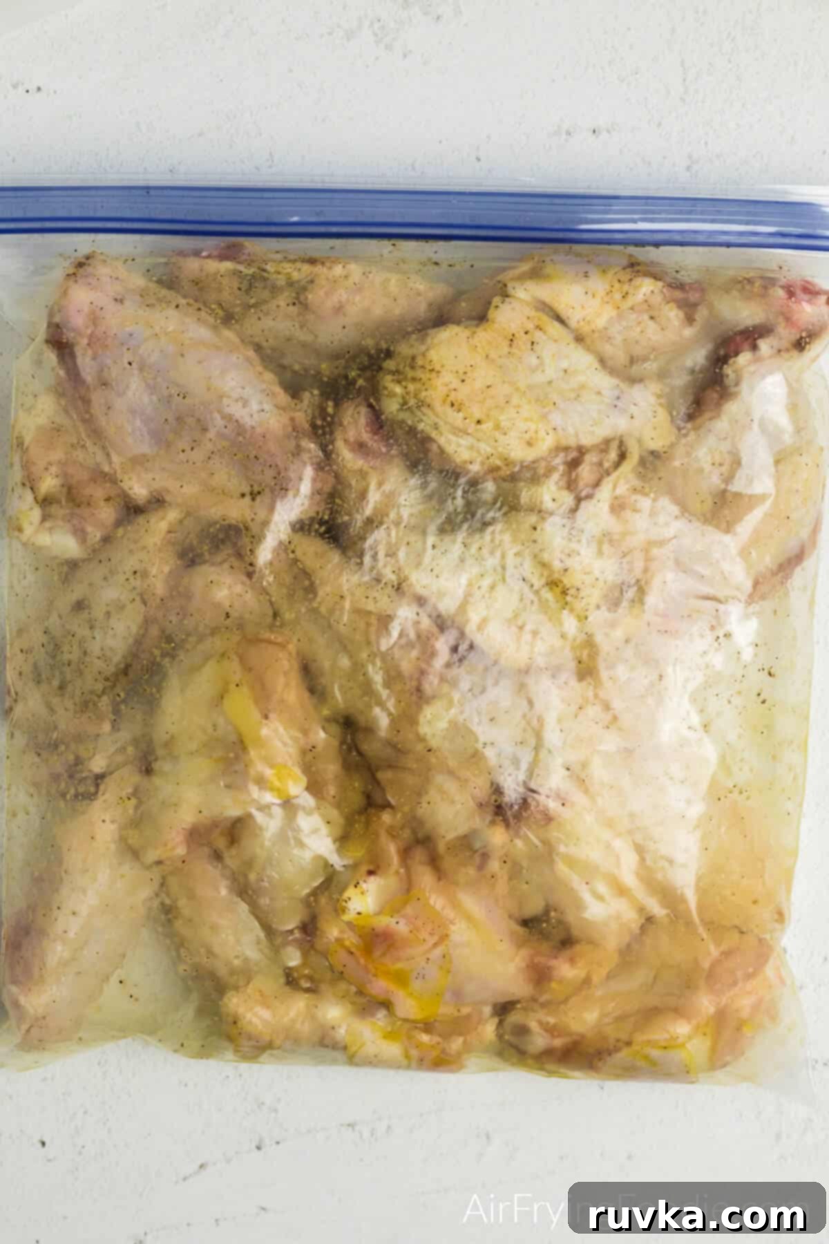 Crispy Air Fryer Buffalo Wings 6 Cut up fresh wings in a plastic sealable bag with olive oil and seasonings.
