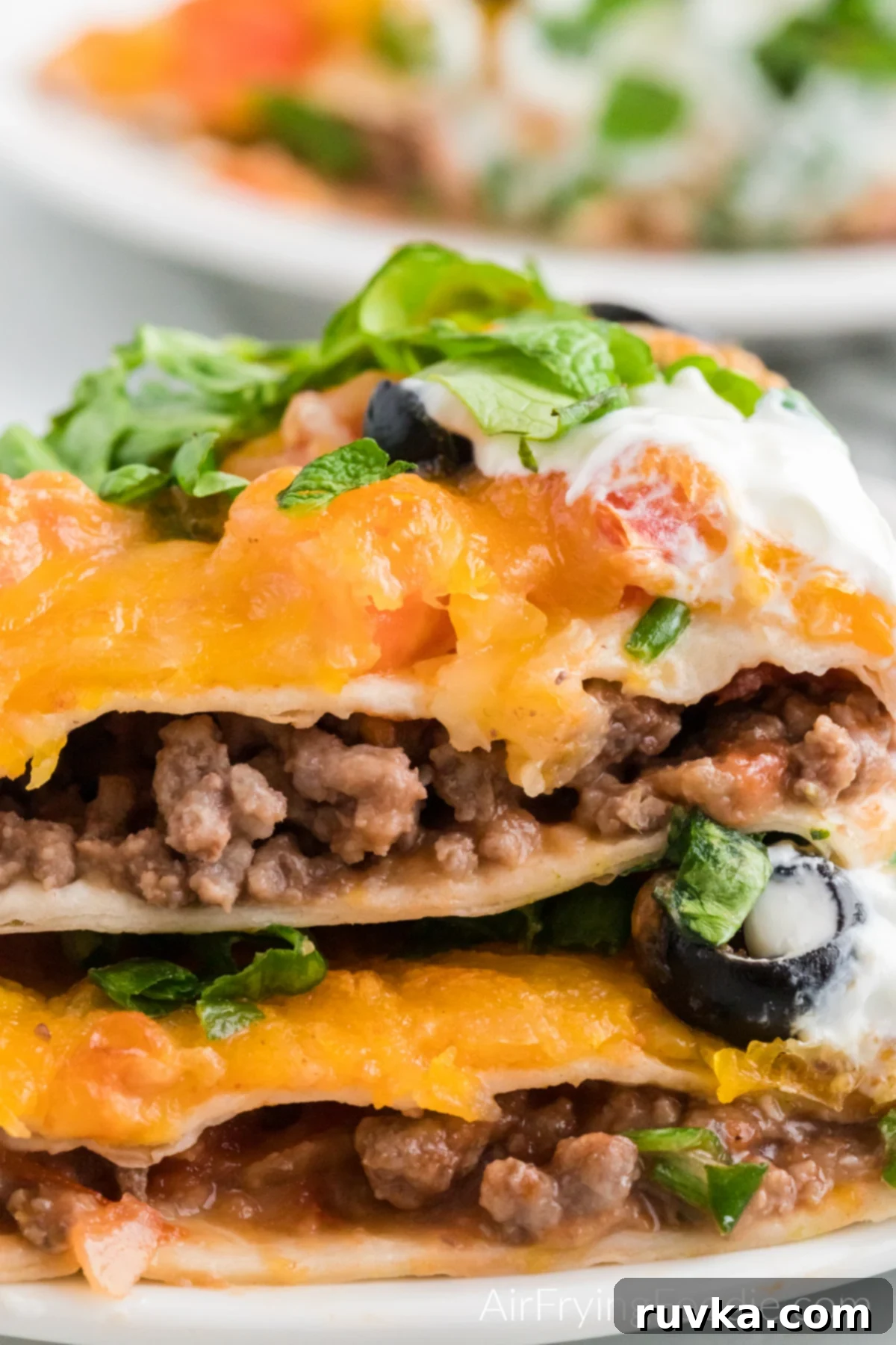 Air Fryer Fiesta Pizza 2 Close up photo of stacked mexican pizza made in the air fryer.