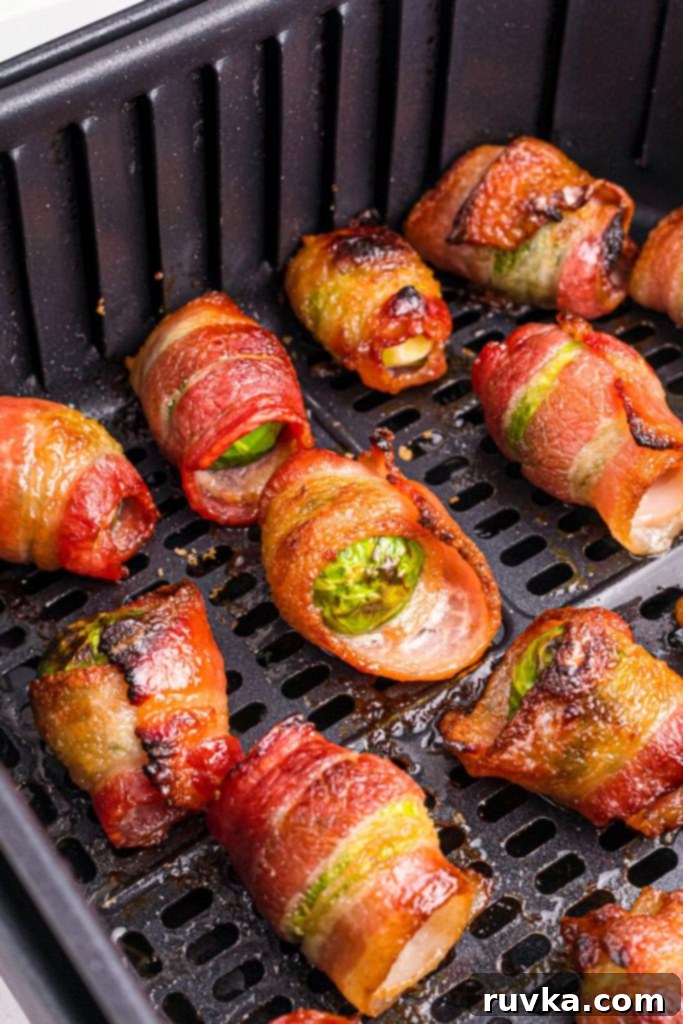 Crispy Air Fryer Bacon Brussels Bites 7 Juicy crispy bacon wrapped around brussels sprouts in the air fryer basket after being cooked