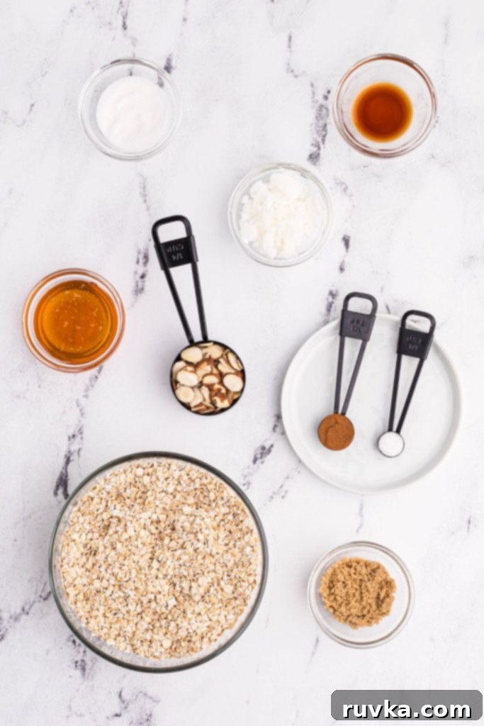 Easy Air Fryer Granola 3 Collection of granola ingredients including oats, almonds, honey, and spices
