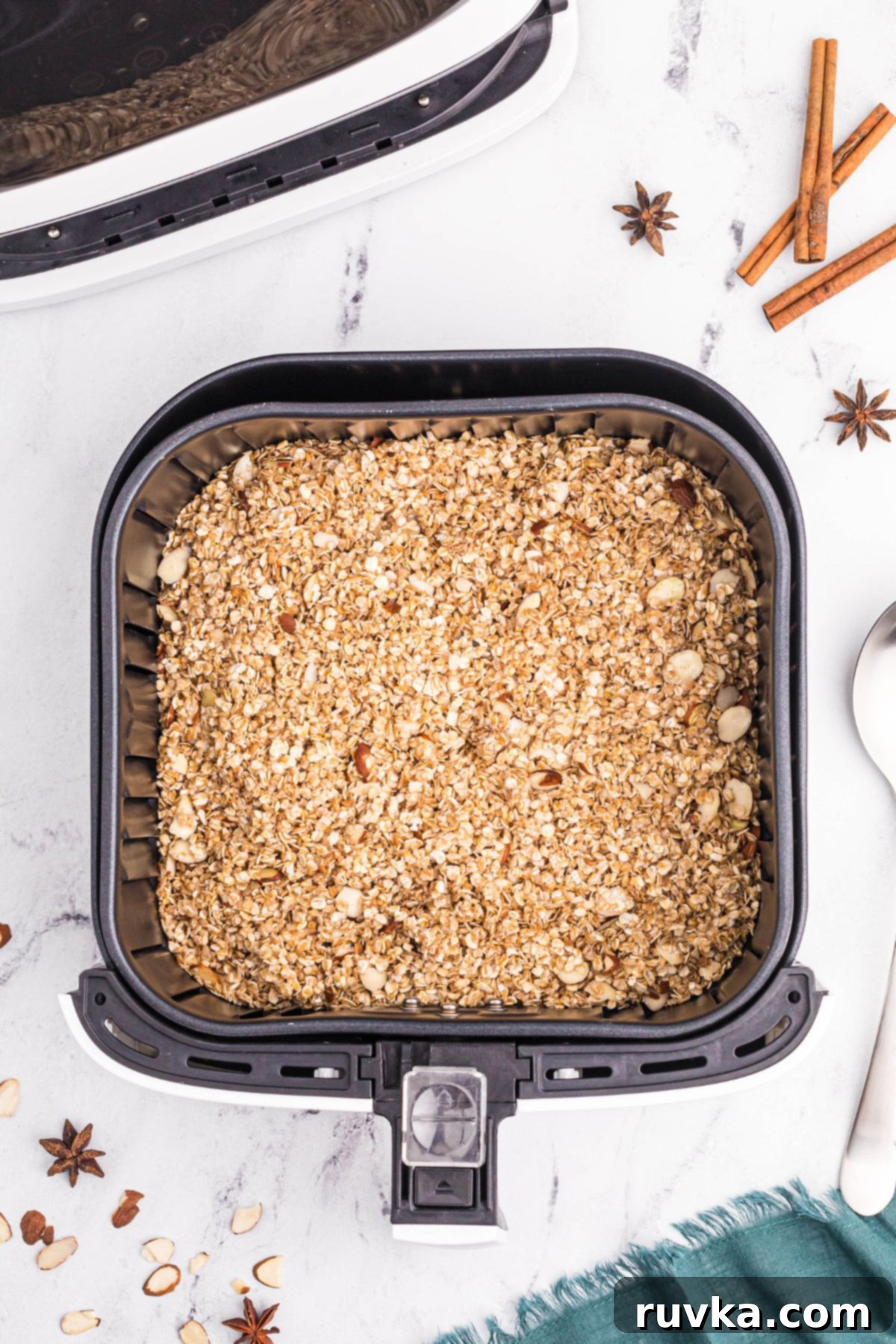 Easy Air Fryer Granola 5 Granola oats mixture in the air fryer basket before being cooked