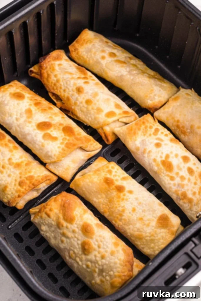 Crispy Air Fryer Shrimp Egg Rolls 8 Golden crispy egg rolls in the air fryer basket