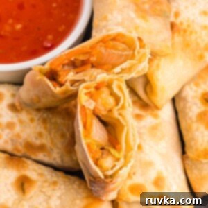 Crispy Air Fryer Shrimp Egg Rolls 10 Golden crispy egg rolls on a plate with dipping sauce