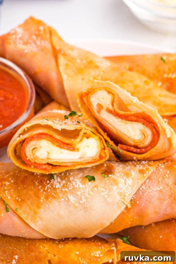 Crispy Air Fryer Pizza Egg Rolls 10 Golden crispy pizza egg rolls frilled with cheese and pepperoni stacked together.