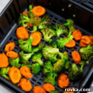Crispy Air Fryer Broccoli and Carrots 9 Broccoli and carrots in the basket of the air fryer.