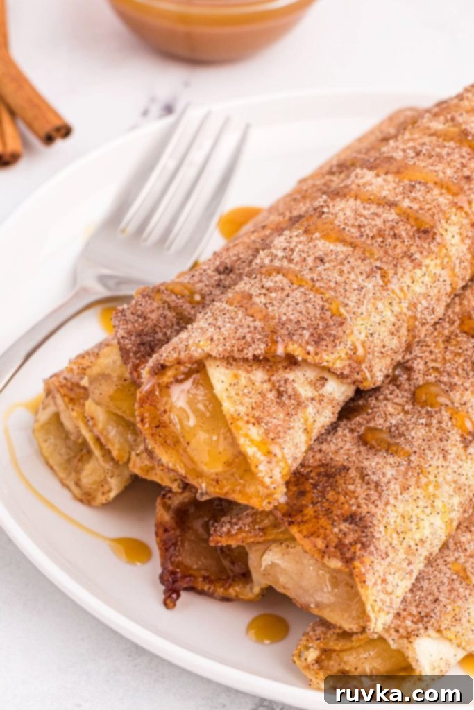 Crispy Air Fryer Apple Pie Taquitos 2 Rolled tortillas filled with apple pie filling and coated in sugar and cinnamon.