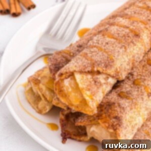 Crispy Air Fryer Apple Pie Taquitos 11 Golden crispy taquitos filled with apple pie filling on a white plate.
