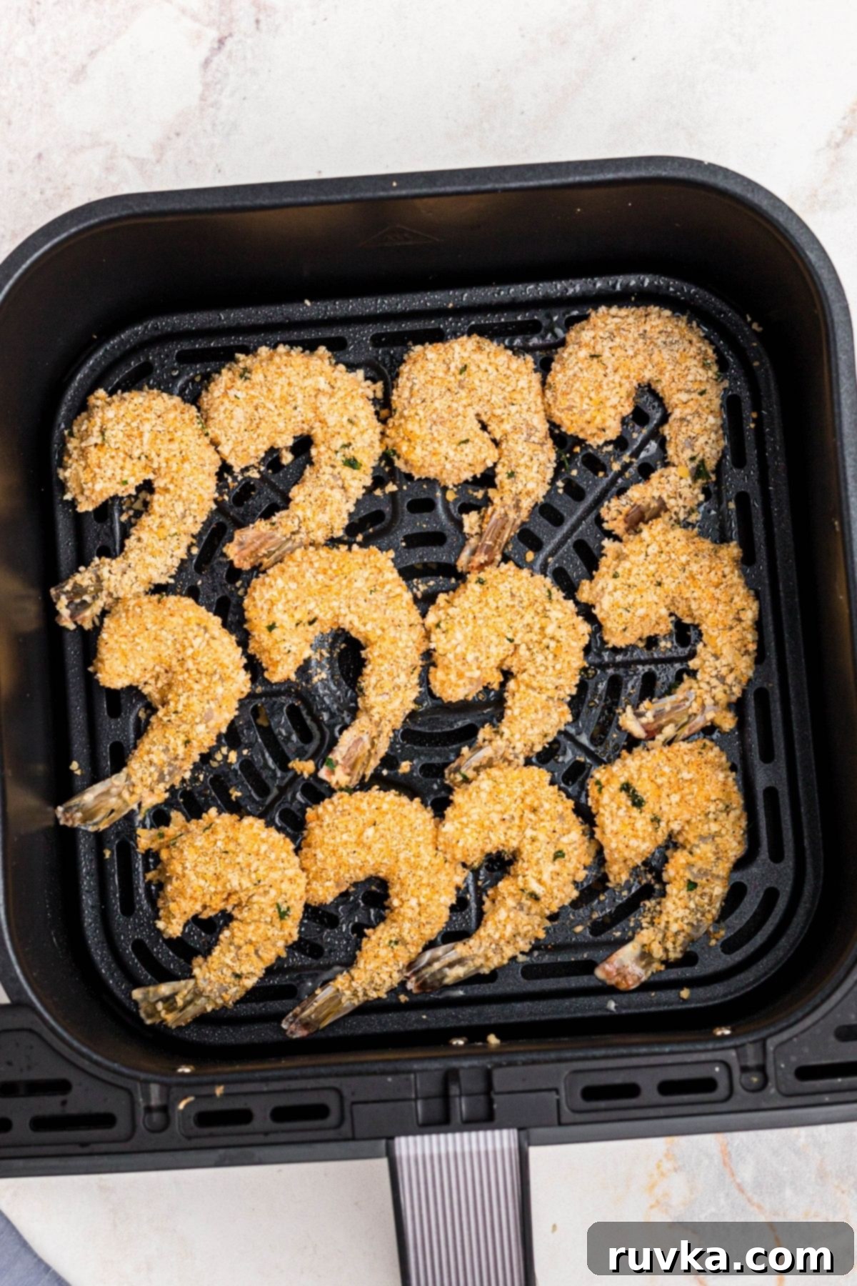 Crispy Air Fryer Breaded Shrimp 7 Battered and coated uncooked shrimp in the air fryer basket