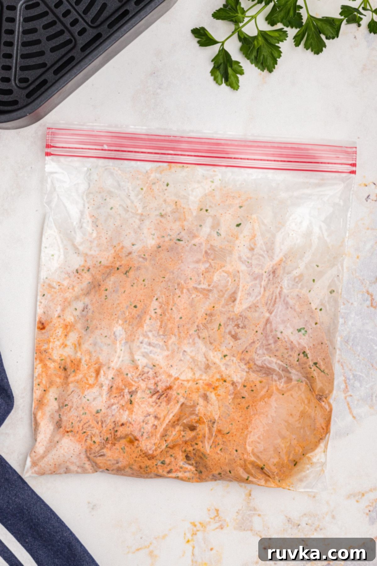 Tender Air Fryer Yogurt Chicken 4 Ziploc bag filled with uncooked chicken breast, yogurt, and seasonings.