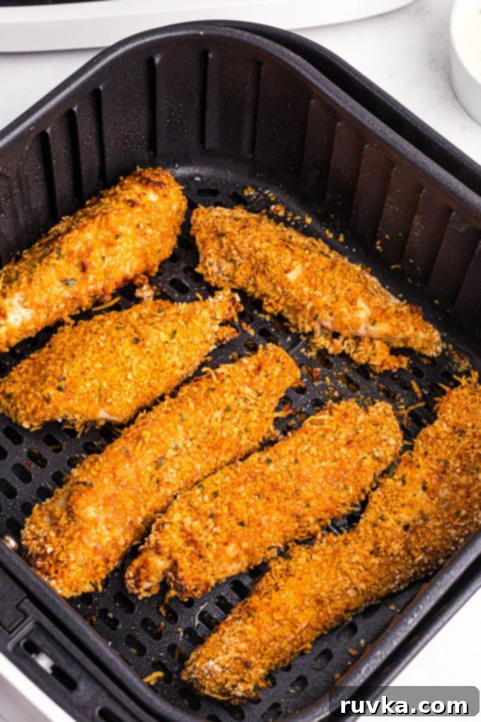 Crispy Golden Oat Air Fryer Chicken 7 Golden crispy coated chicken in the air fryer basket.