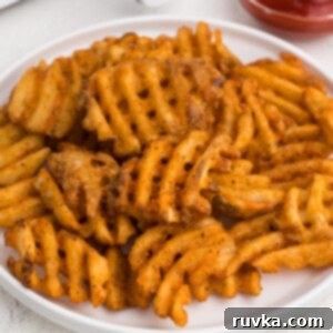 Crispy Air Fryer Waffle Fries 8 Waffle fries made in the air fryer, served on a white plate.