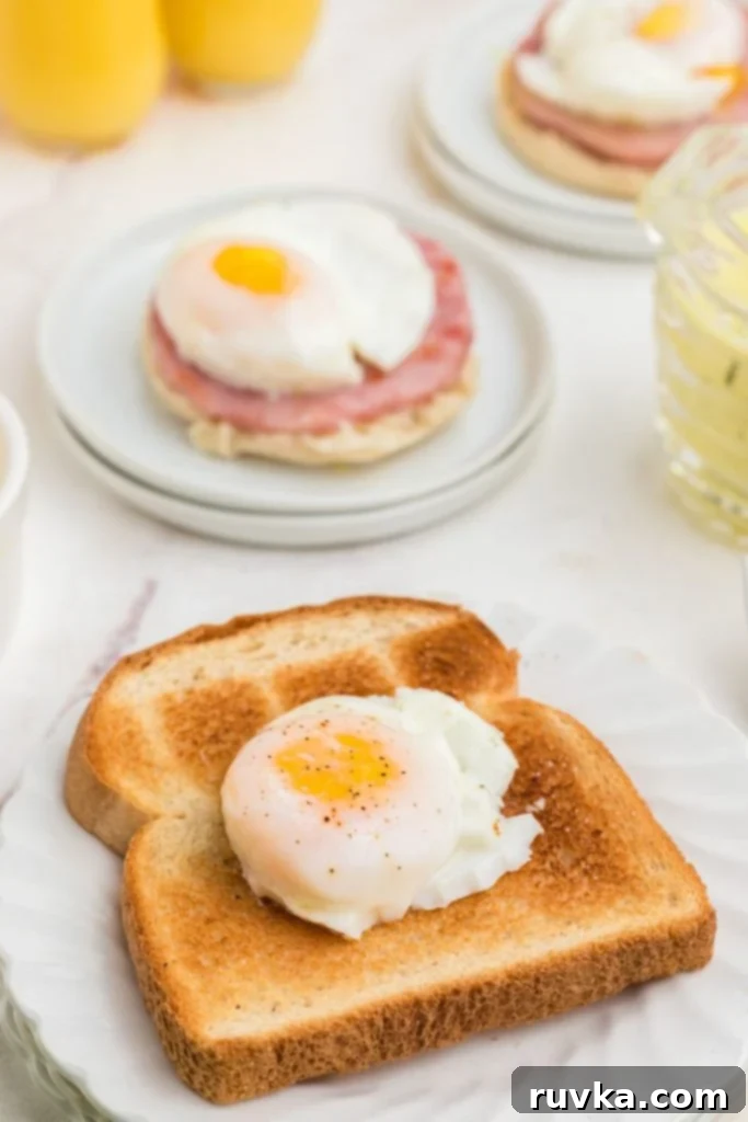 Perfect Air Fryer Poached Eggs 7 Poached egg on a piece of toast on a white plate