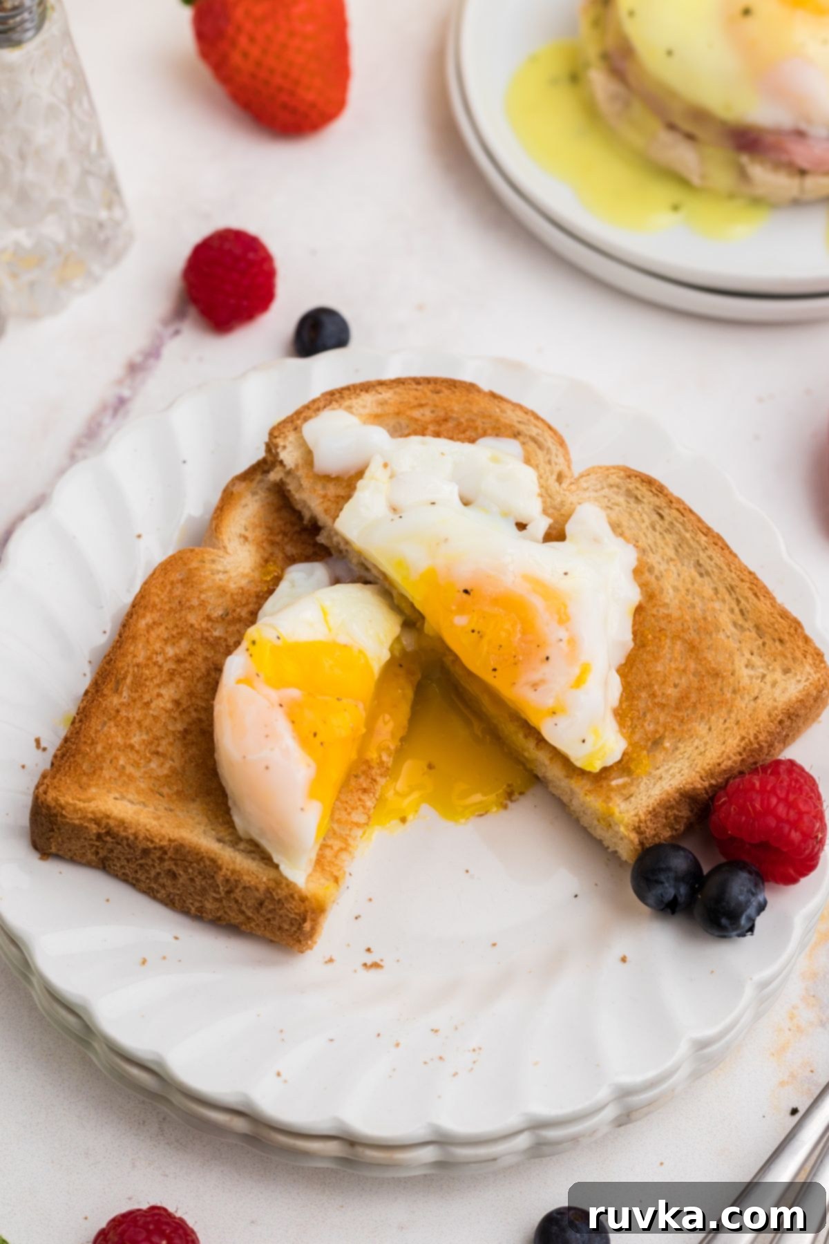 Perfect Air Fryer Poached Eggs 8 Poached eggs on a white plate.