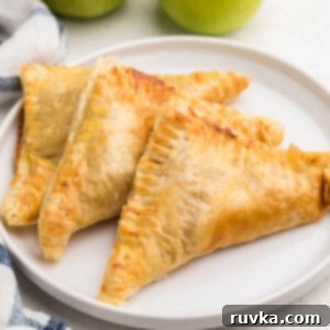 Crispy Air Fryer Apple Turnovers 11 Air fried apple turnovers on a white plate, ready to eat.