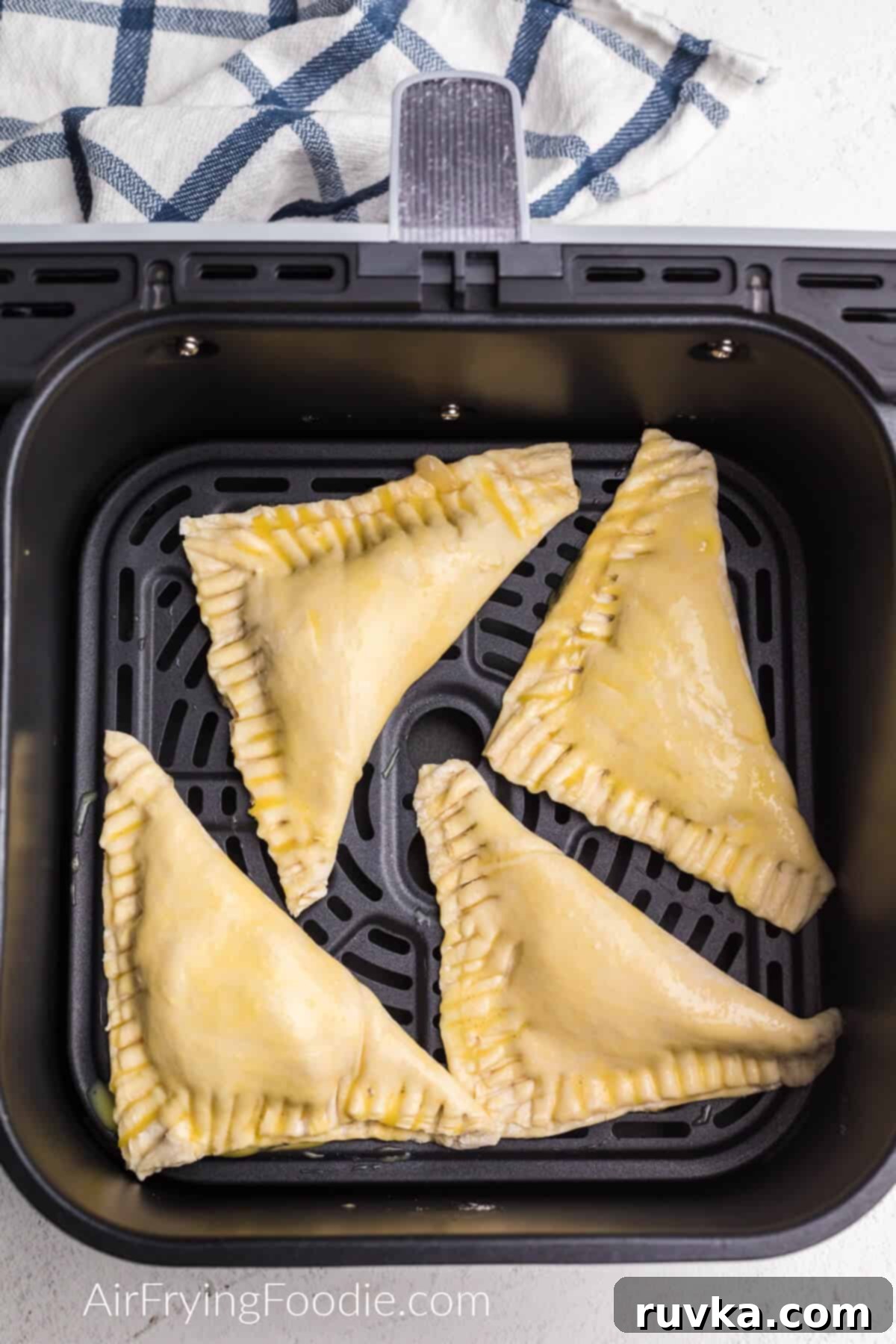 Crispy Air Fryer Apple Turnovers 6 Apple turnovers in the basket of the air fryer.