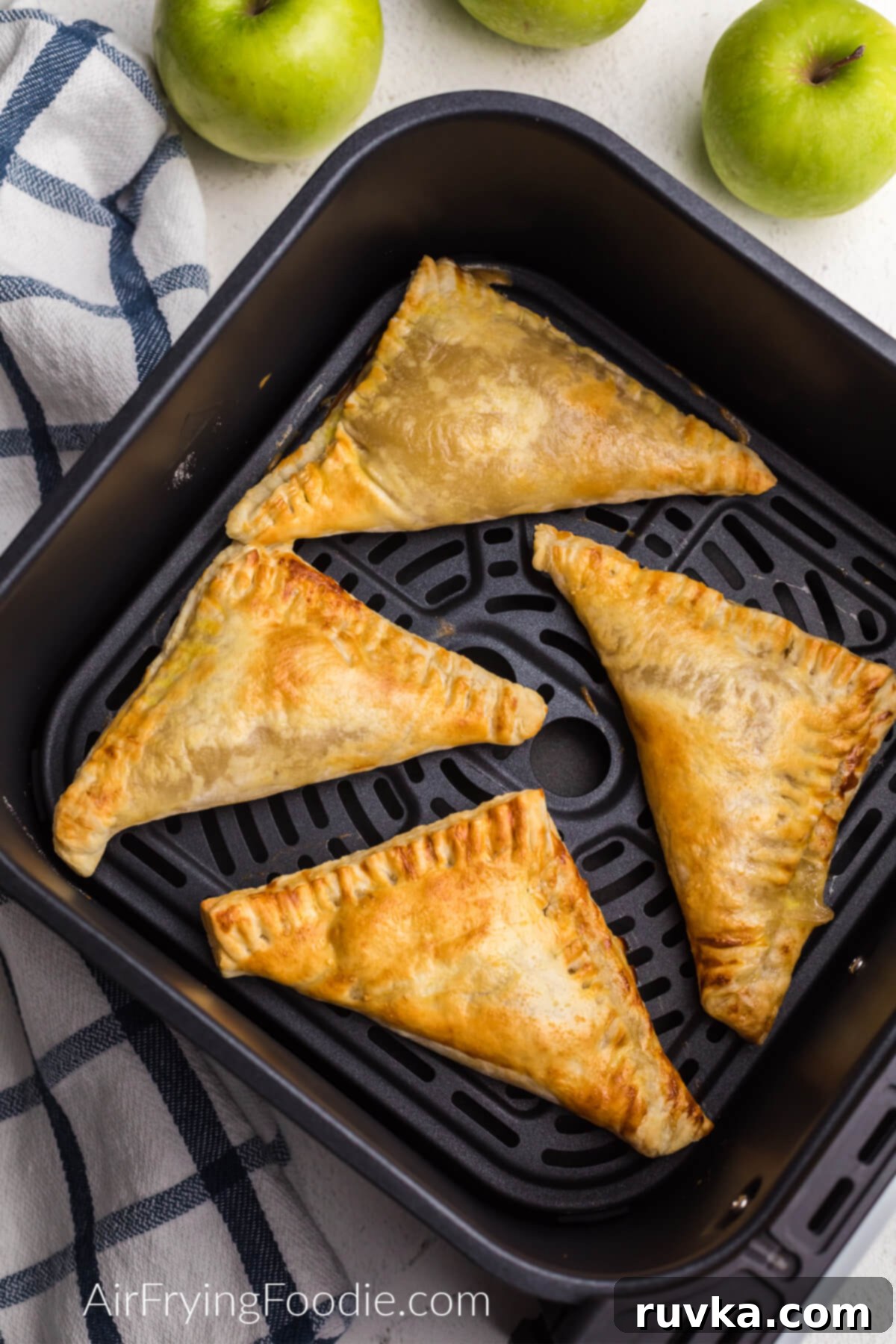 Crispy Air Fryer Apple Turnovers 7 Air fried apple turnovers golden and crispy in the basket of the air fryer.