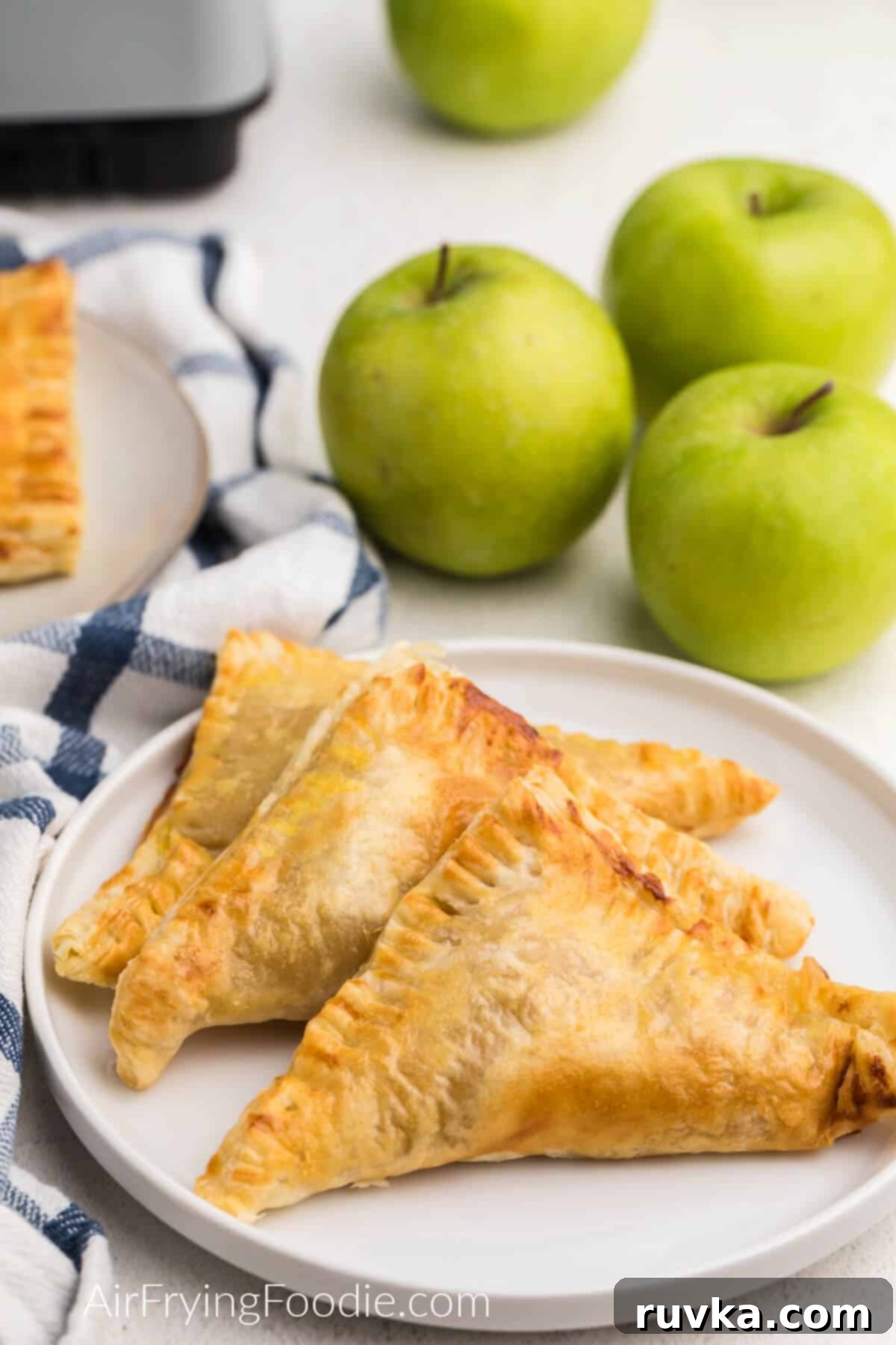 Crispy Air Fryer Apple Turnovers 9 Air fryer apple turnovers served on a white plate, ready to eat.