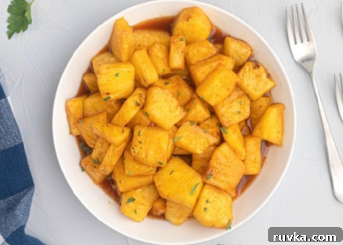 Air Fried Honey BBQ Pineapple 3 Juicy pineapple in a white bowl, glistening with honey and bbq juices after being cooked in the air fryer.