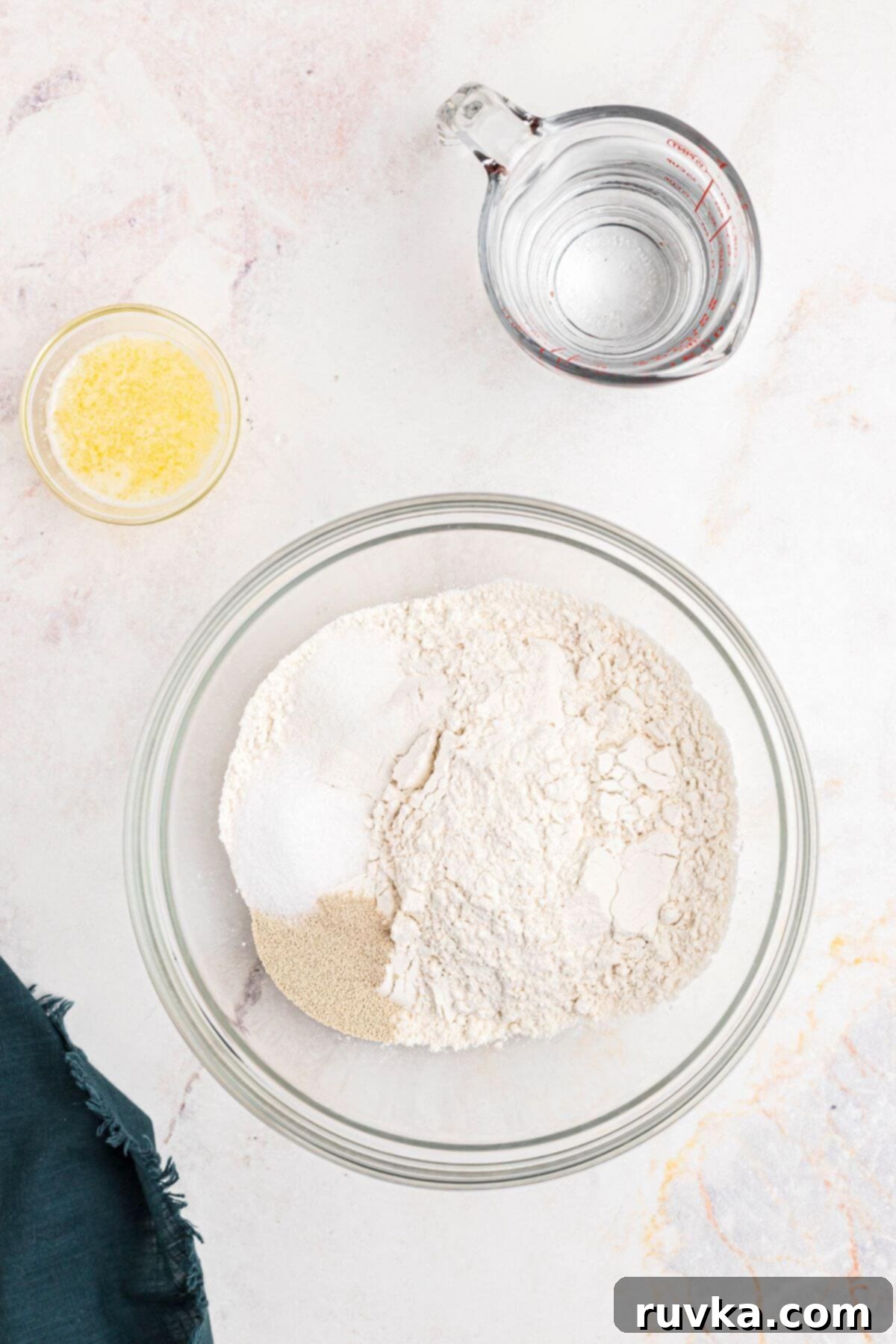 Perfectly Soft Air Fryer Pretzels 4 Flour, salt and yeast being mixed in a clear glass bowl.